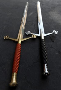 Two swords, one red handled and gold blad, one black handled and silver blade
