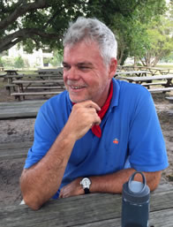 Photo of James Loehlin at picnic table