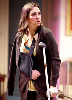 Holly Twyford as Sarah on crutches, arm in sling, and bloody wounds on her face and neck