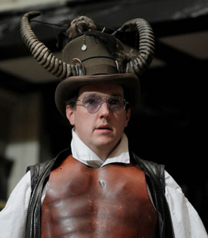 John Harrell as Lucifer in ram horns, breast plate and sunglasses