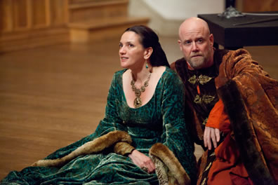 Eleanor in green dress and Henry in red fur robes sit on the Blackfriars stage in The Lion in Winter