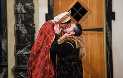 Production photo by Marek K. Photography of Hermione kissing the kneeling Leontes