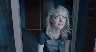 Sam, straggly blond hair, patterend athletic tee-shirt, is looking up outside a window, a look of wonder on her face, and in the background is a room with a door.