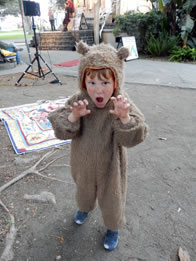 Photo of boy in bear suit growling