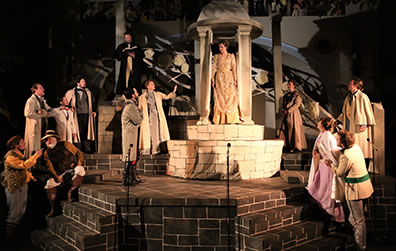 Production photo of the full set and the cast in the final scene, Hermione standing inside the cupolo center stage.