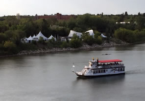 Photo of tents by the river and river boat