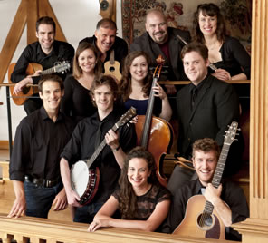 A group portrait of the tour actors, with their musical instruments: guitar, banjo, cello, flute