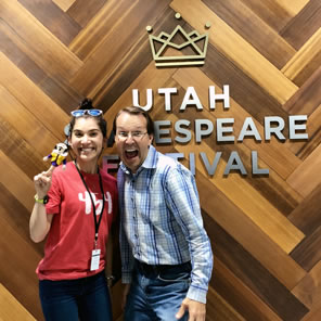 Photo of Dickson and Bahr in fron of Utah Shakespeare Festival wall